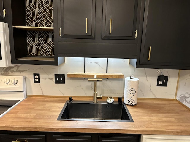 kitchen featuring white appliances, tasteful backsplash, and sink