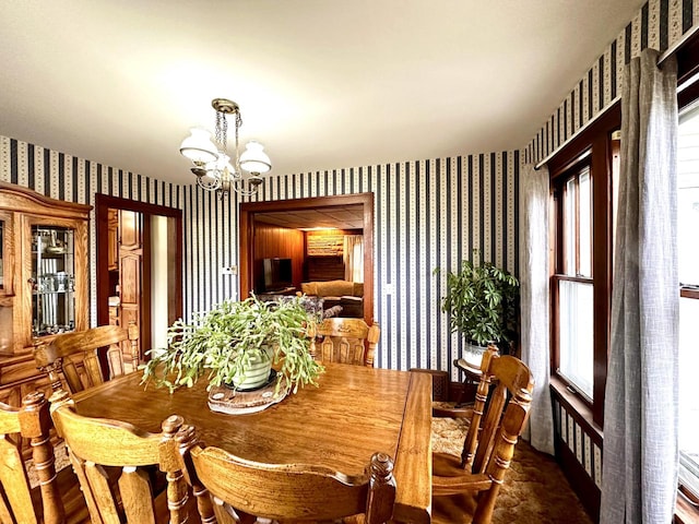 dining room with a healthy amount of sunlight and a notable chandelier