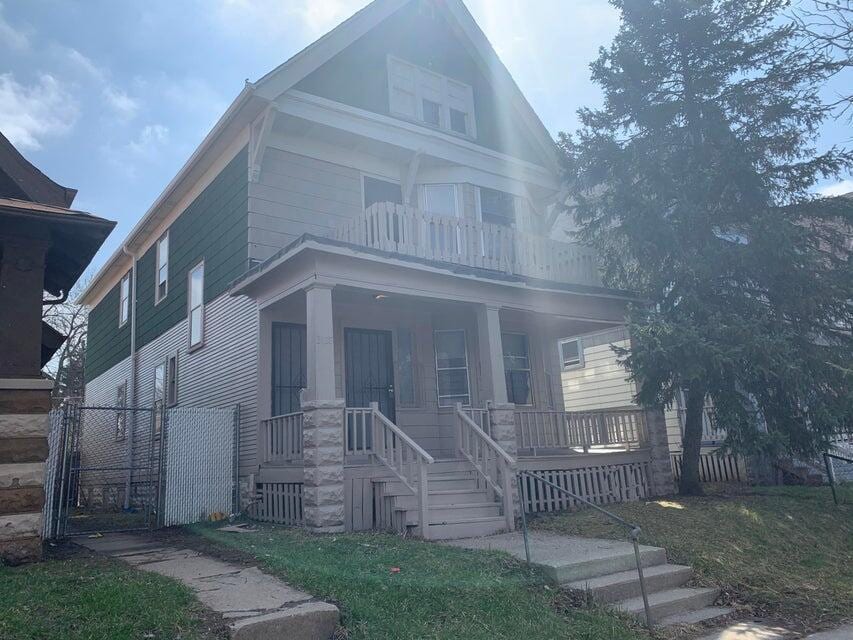 view of front facade featuring a balcony and a porch