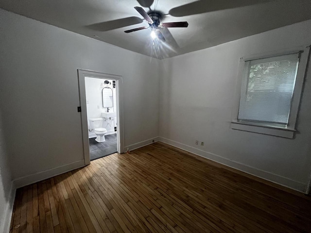 spare room featuring ceiling fan and dark wood-type flooring