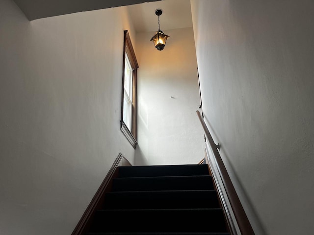 staircase featuring lofted ceiling