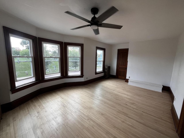 spare room featuring ceiling fan and light hardwood / wood-style flooring