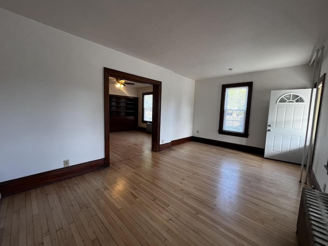 unfurnished room featuring ceiling fan and light wood-type flooring