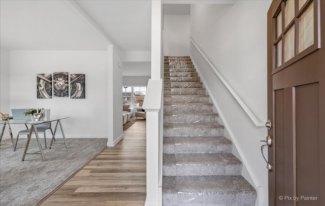 stairs featuring wood-type flooring