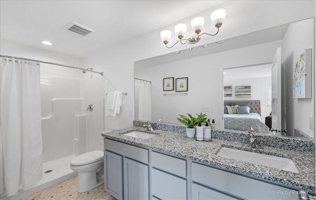 bathroom with walk in shower, vanity, and toilet