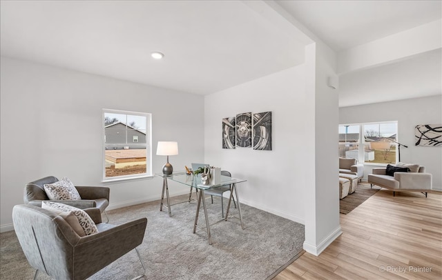 home office with light hardwood / wood-style floors