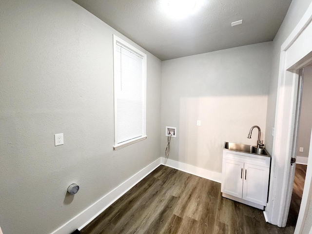 laundry area with cabinets, sink, hookup for a washing machine, and dark wood-type flooring