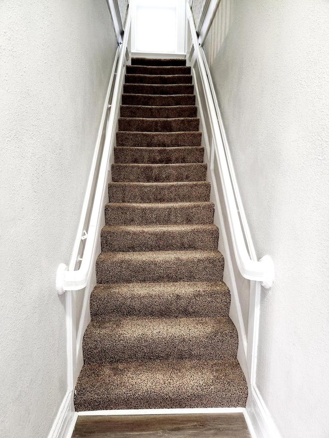 staircase featuring hardwood / wood-style floors