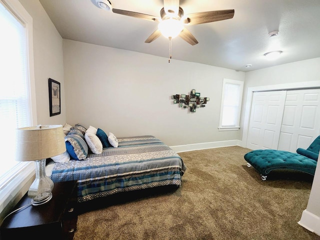 carpeted bedroom with ceiling fan and a closet