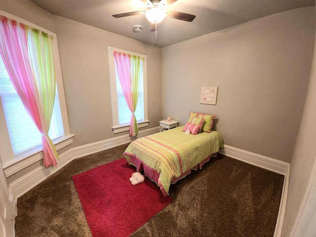 carpeted bedroom with multiple windows and ceiling fan