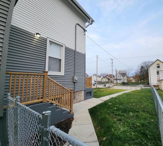 view of side of property with a lawn