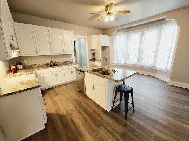 kitchen featuring a kitchen island with sink, sink, dishwasher, white cabinets, and dark hardwood / wood-style floors