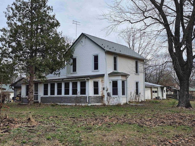 back of house with a sunroom