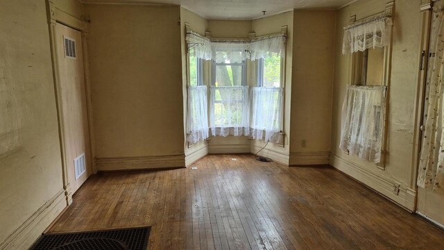 33135 Fulton St, Lone Rock, WI 53556 - unfurnished room with hardwood / wood-style floors, baseboards, and crown molding