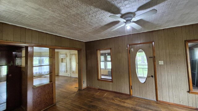 33135 Fulton St, Lone Rock, WI 53556 - entryway with hardwood / wood-style floors, ceiling fan, wood walls, and baseboards