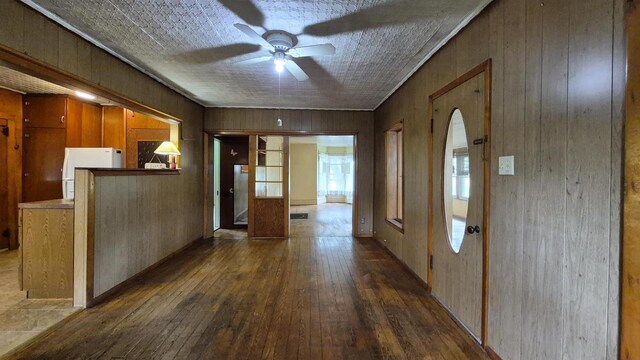 33135 Fulton St, Lone Rock, WI 53556 - entrance foyer with dark wood-style floors, a ceiling fan, wood walls, and arched walkways