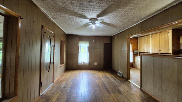 33135 Fulton St, Lone Rock, WI 53556 - spare room featuring wood-type flooring, wood walls, and ceiling fan