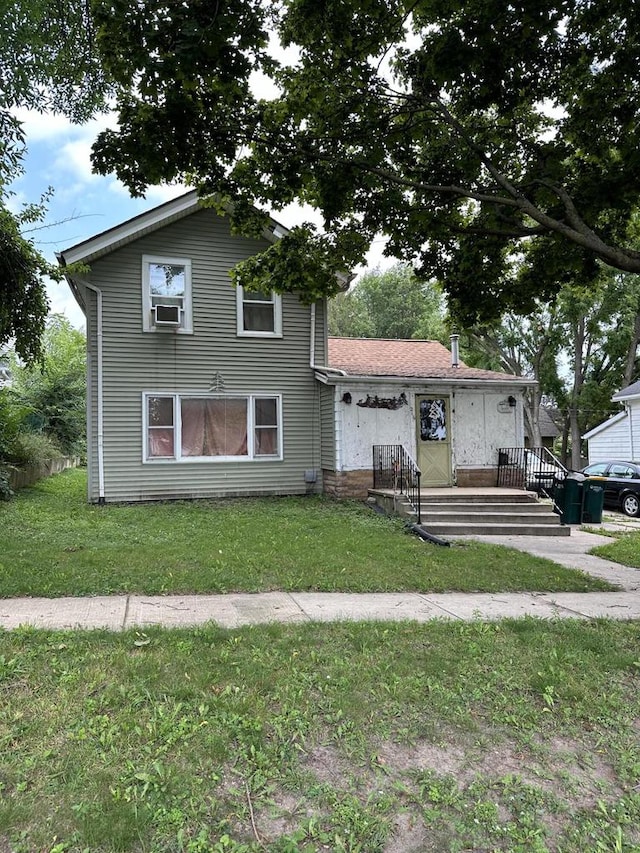 view of front of house with cooling unit and a front yard