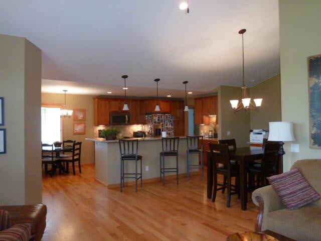 living room featuring an inviting chandelier and light wood-type flooring