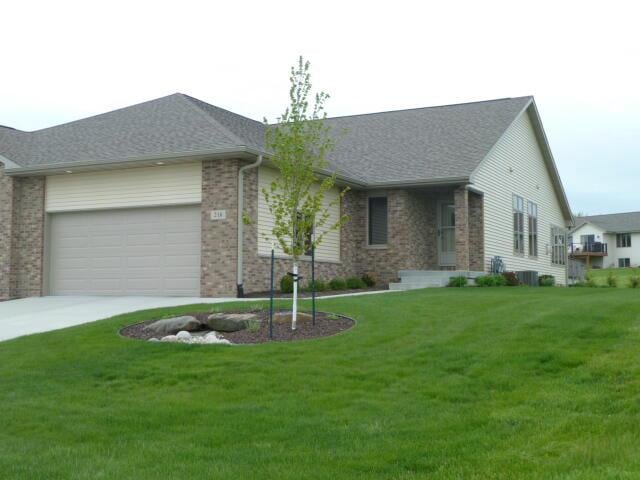 single story home with a front lawn and a garage