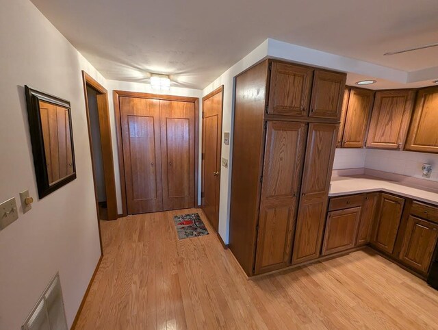 kitchen featuring backsplash and light hardwood / wood-style flooring