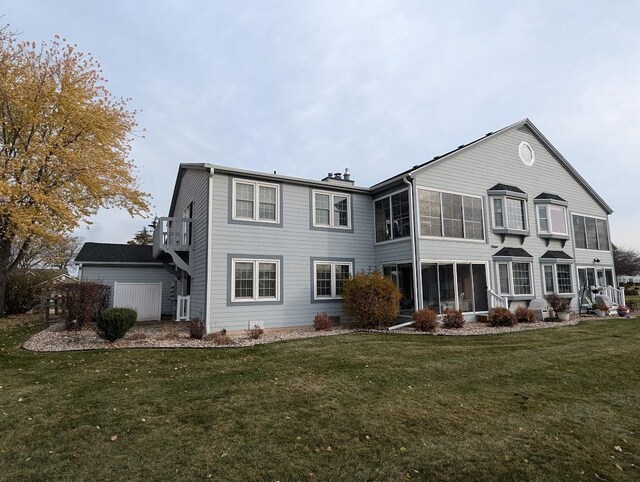 back of house featuring central AC, a sunroom, and a yard