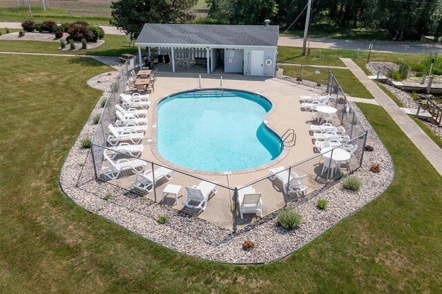 view of pool featuring a lawn and a patio area