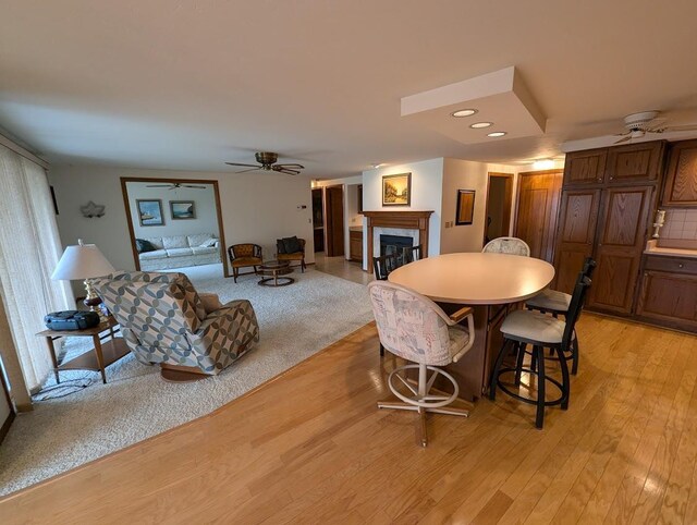 dining space featuring ceiling fan and light hardwood / wood-style floors