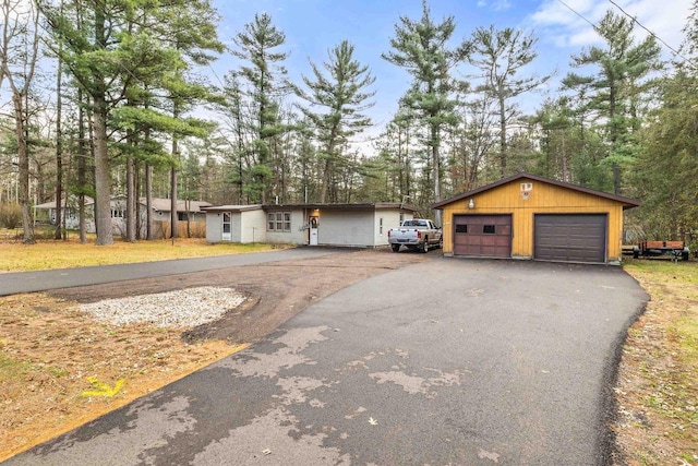 single story home with an outbuilding and a garage