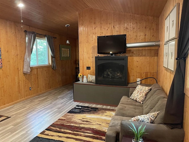 living room featuring hardwood / wood-style floors, lofted ceiling, wooden walls, and wooden ceiling