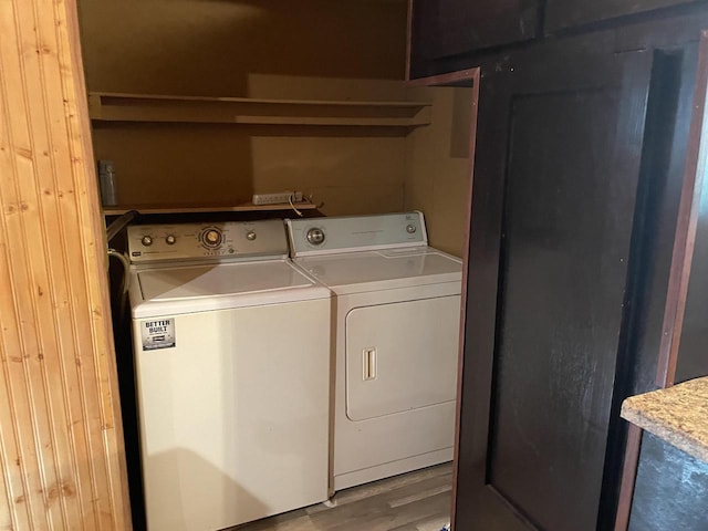 laundry area with washing machine and dryer and light hardwood / wood-style floors