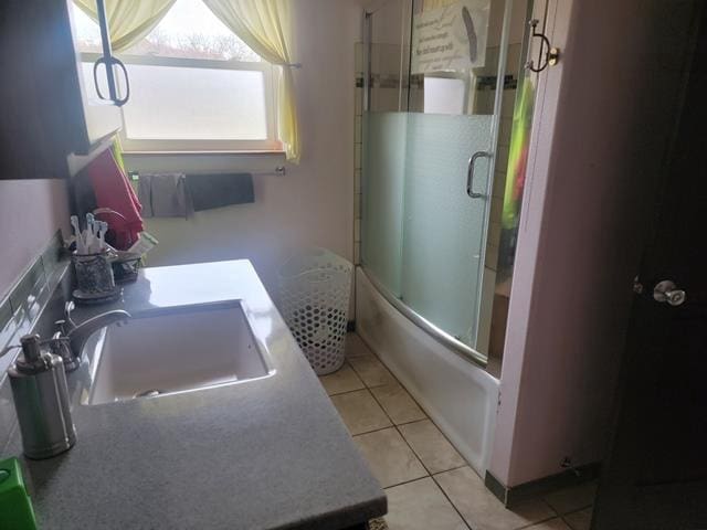 bathroom featuring shower / bath combination with glass door, tile patterned flooring, and vanity