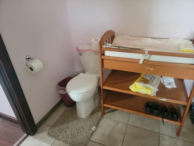 bathroom with tile patterned flooring and toilet