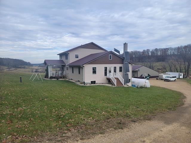 rear view of house with a yard