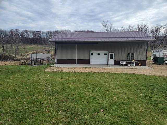 view of outbuilding featuring a lawn and a garage