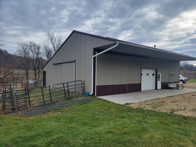 view of outbuilding with a garage and a yard