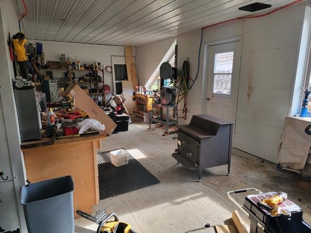 miscellaneous room with a workshop area and concrete floors