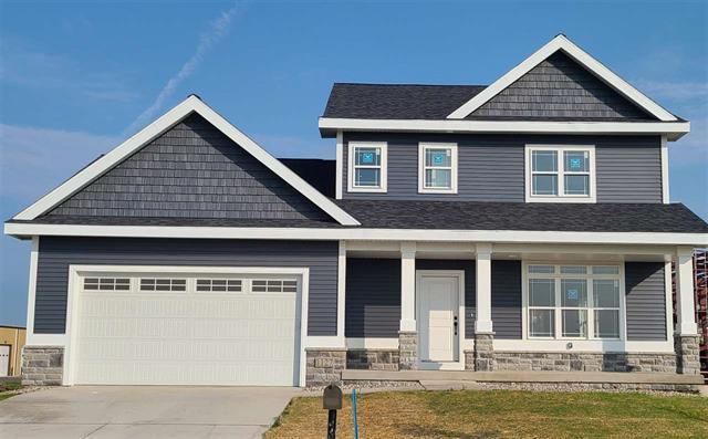 craftsman inspired home featuring a front yard, a porch, and a garage