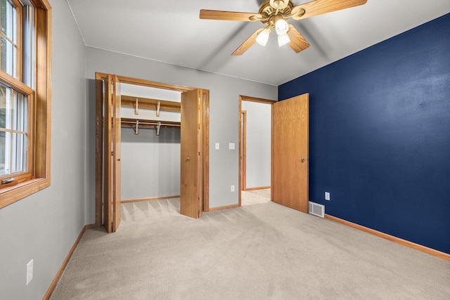 unfurnished bedroom featuring ceiling fan, carpet floors, and a closet