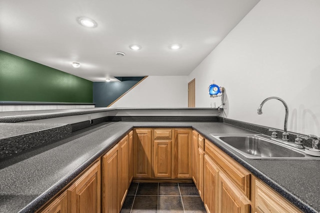 kitchen featuring dark tile patterned floors and sink