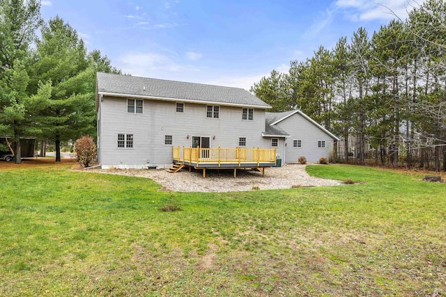 rear view of house with a lawn and a deck