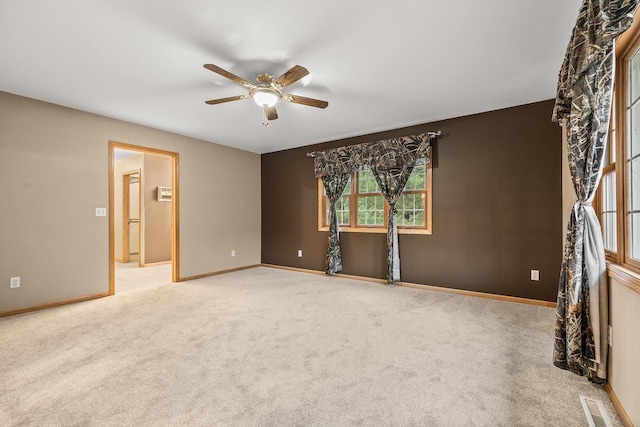 carpeted empty room with ceiling fan