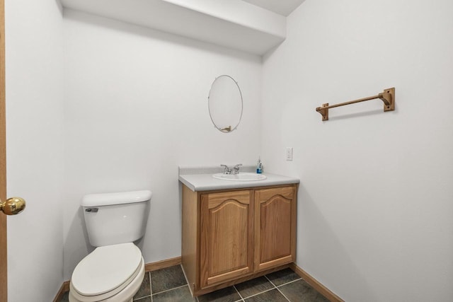 bathroom with tile patterned flooring, vanity, and toilet