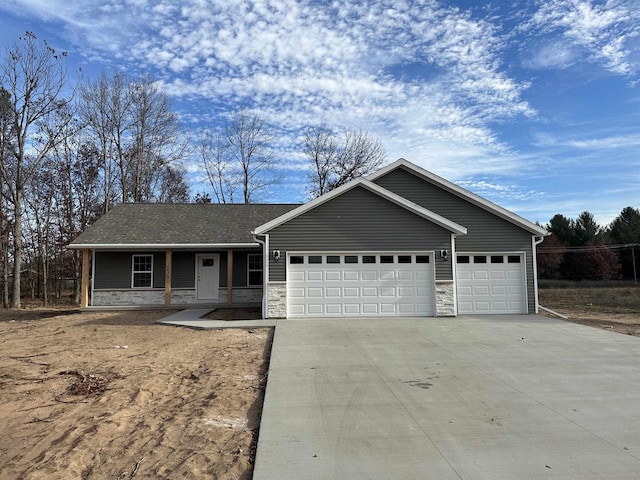 ranch-style home featuring a porch and a garage