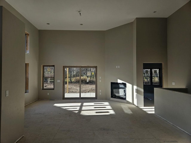 unfurnished living room with a high ceiling