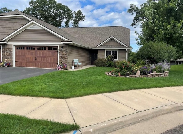 view of front facade with a garage and a front lawn