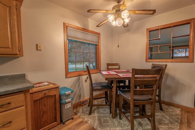 dining room with light wood-type flooring and ceiling fan