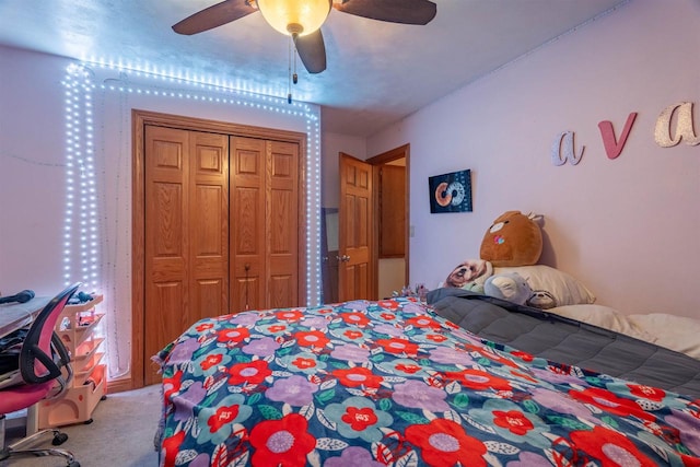 bedroom featuring ceiling fan, a closet, and carpet