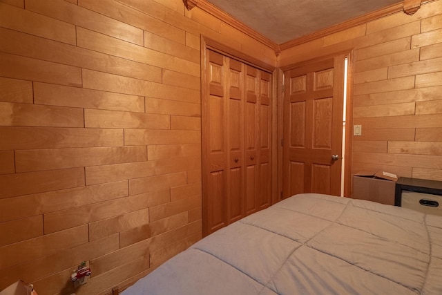 unfurnished bedroom featuring wood walls, ornamental molding, and a closet