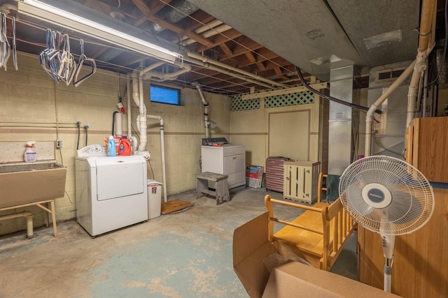 basement featuring washer and dryer and sink